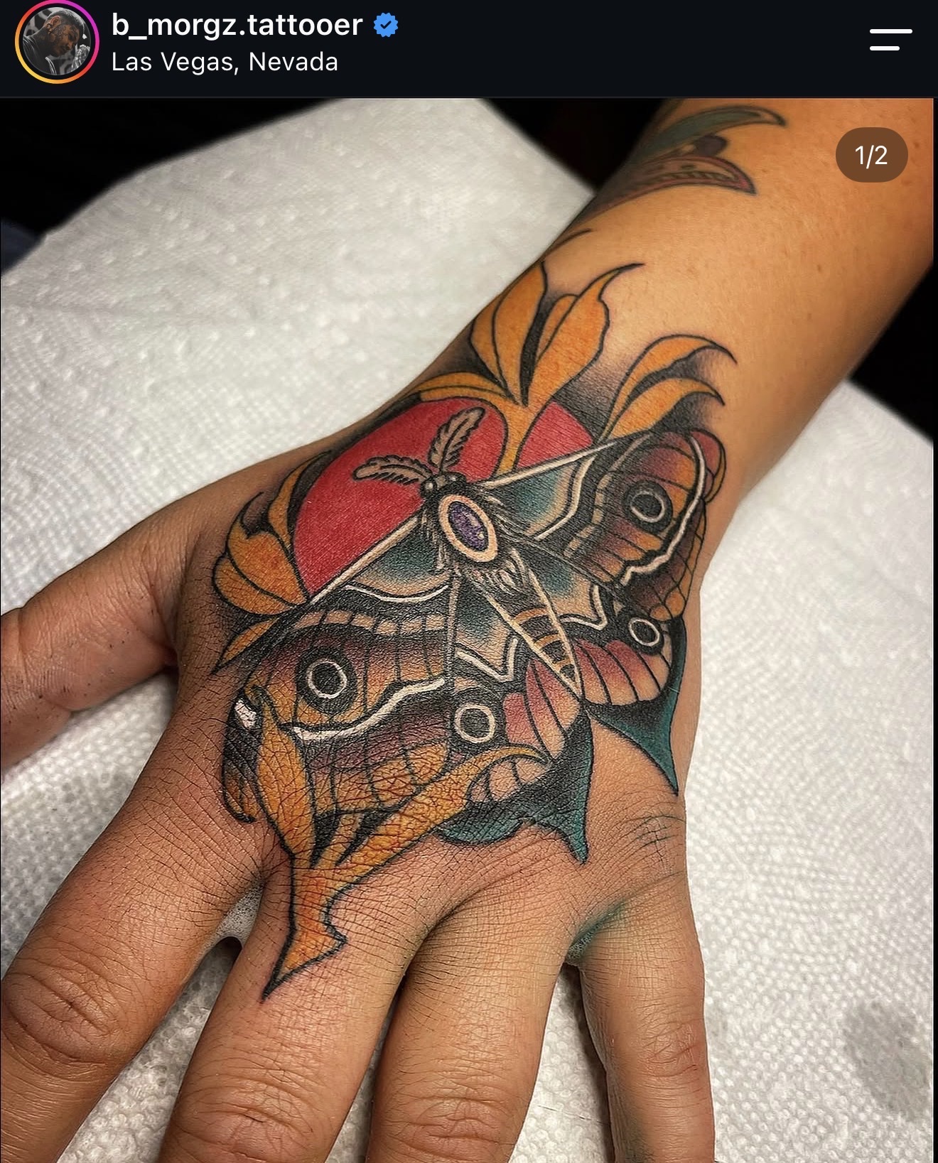 Full color, Neo traditional moth on the top of a hand