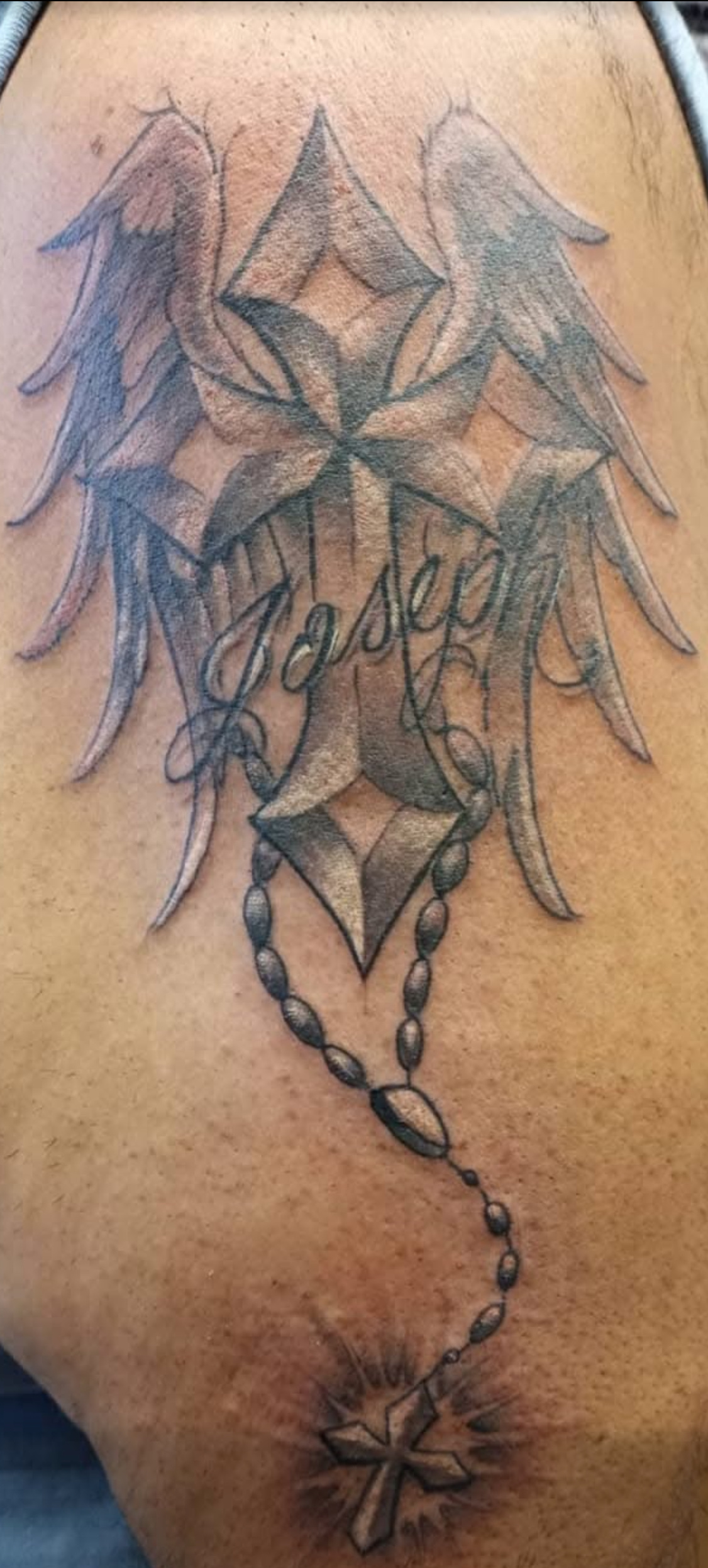 Cross tattoo with wings
