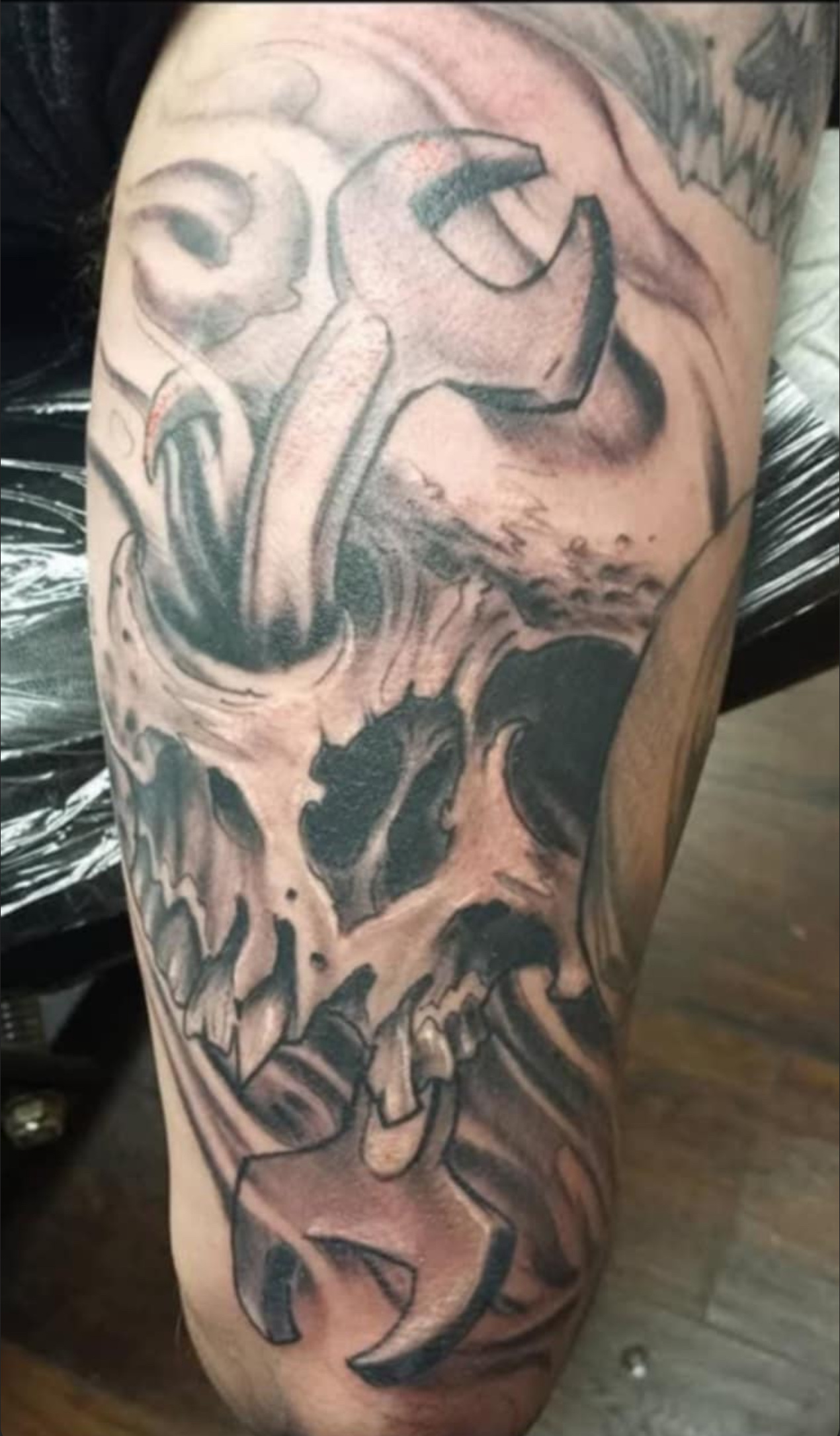 Black and gray skull with wrench