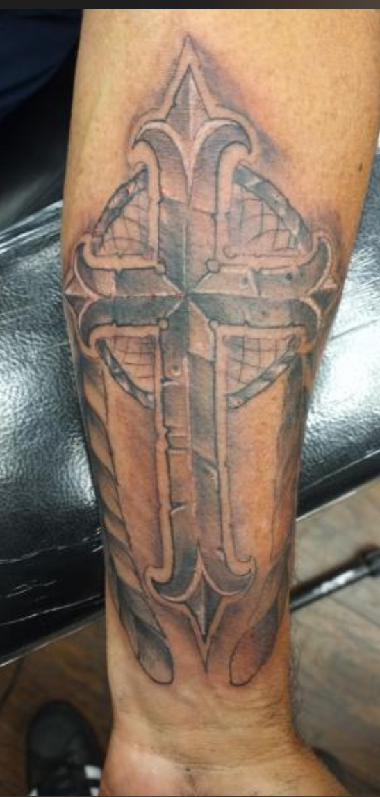 Black and gray stone cross with dream catcher and feathers